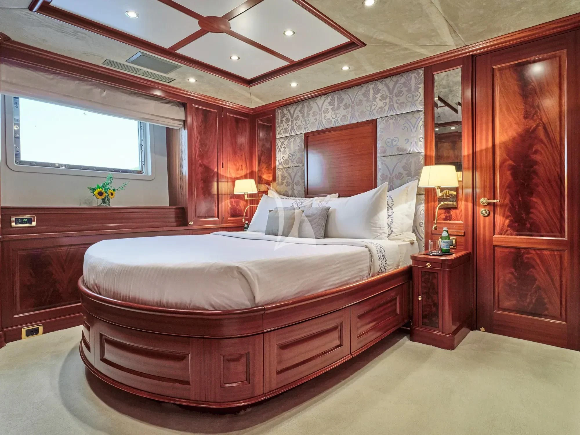 a bedroom with a large bed aboard OPTION B Yacht for Charter