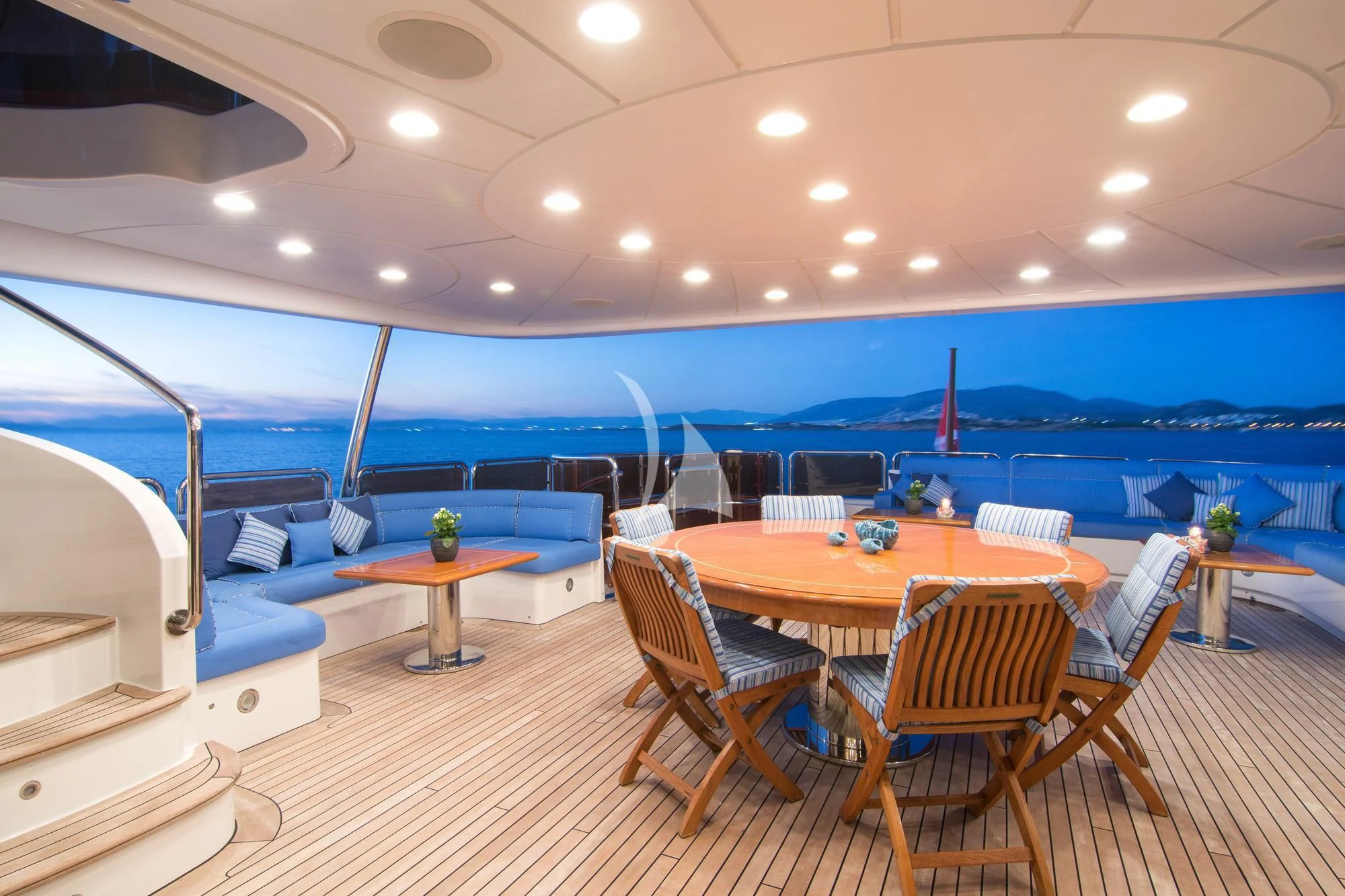 a room with a pool and a table and chairs aboard OPTION B Yacht for Charter