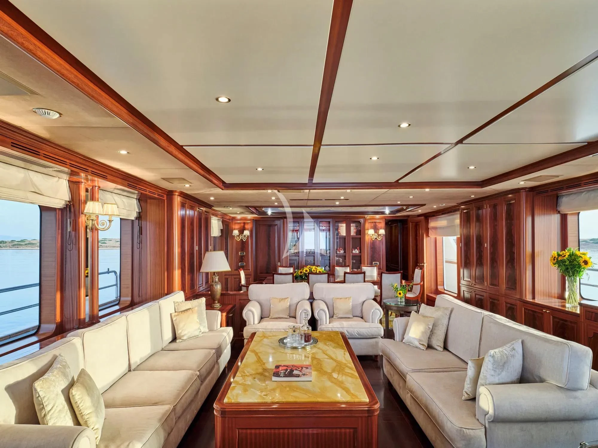 a living room with a couch and a table aboard OPTION B Yacht for Charter