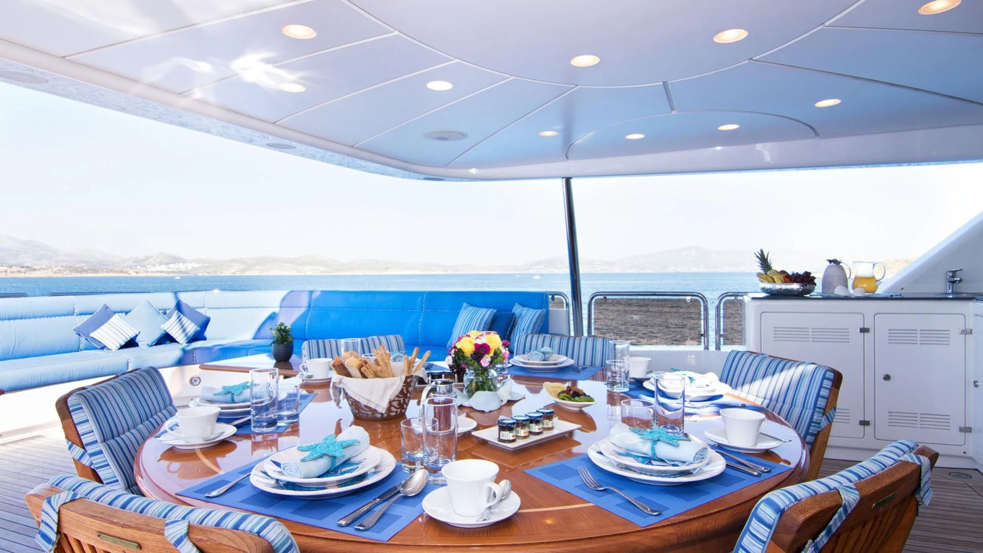 a table with plates and cups on it aboard OPTION B Yacht for Charter