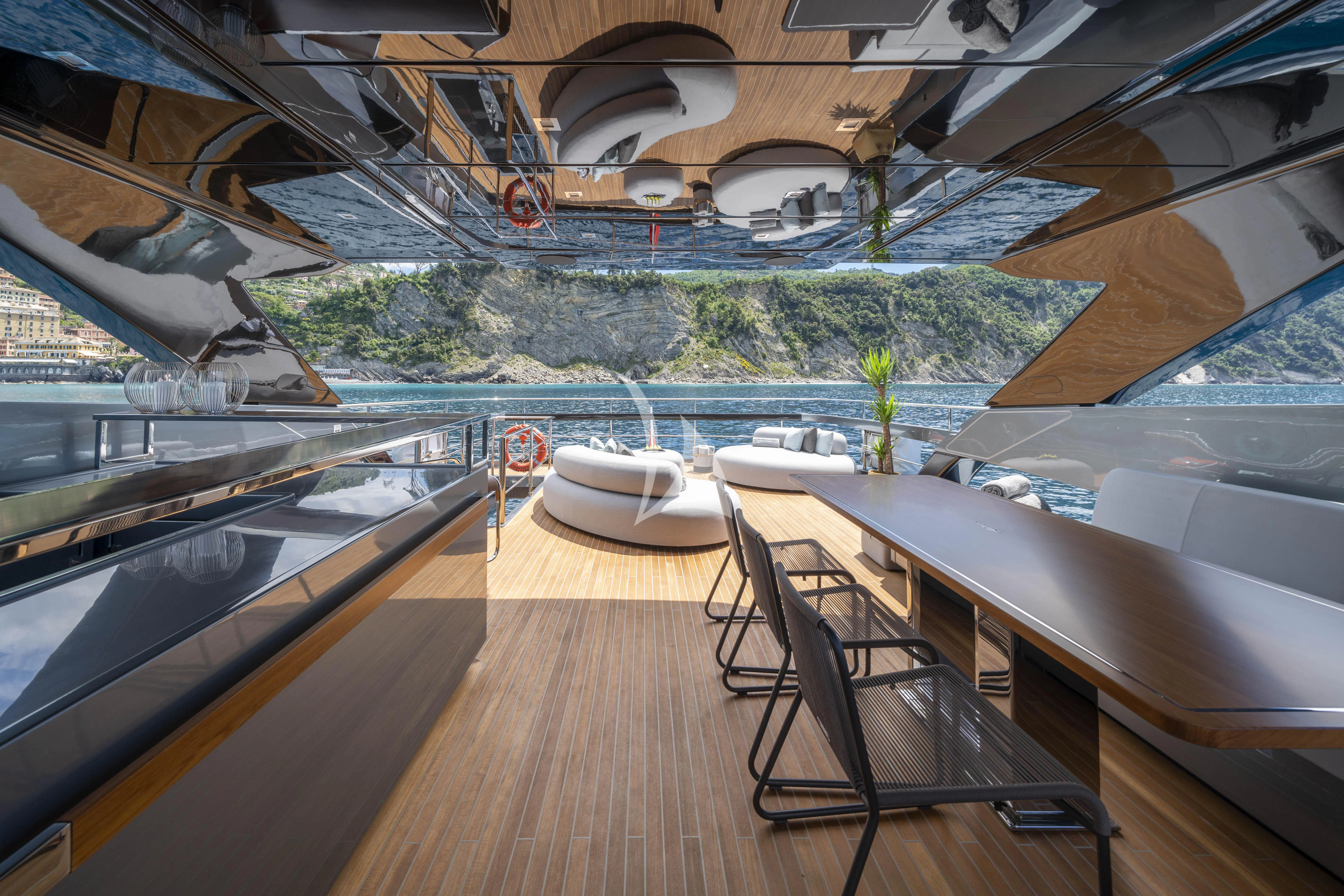 a wooden deck with a view of a lake and a pool aboard HP6 Yacht for Charter