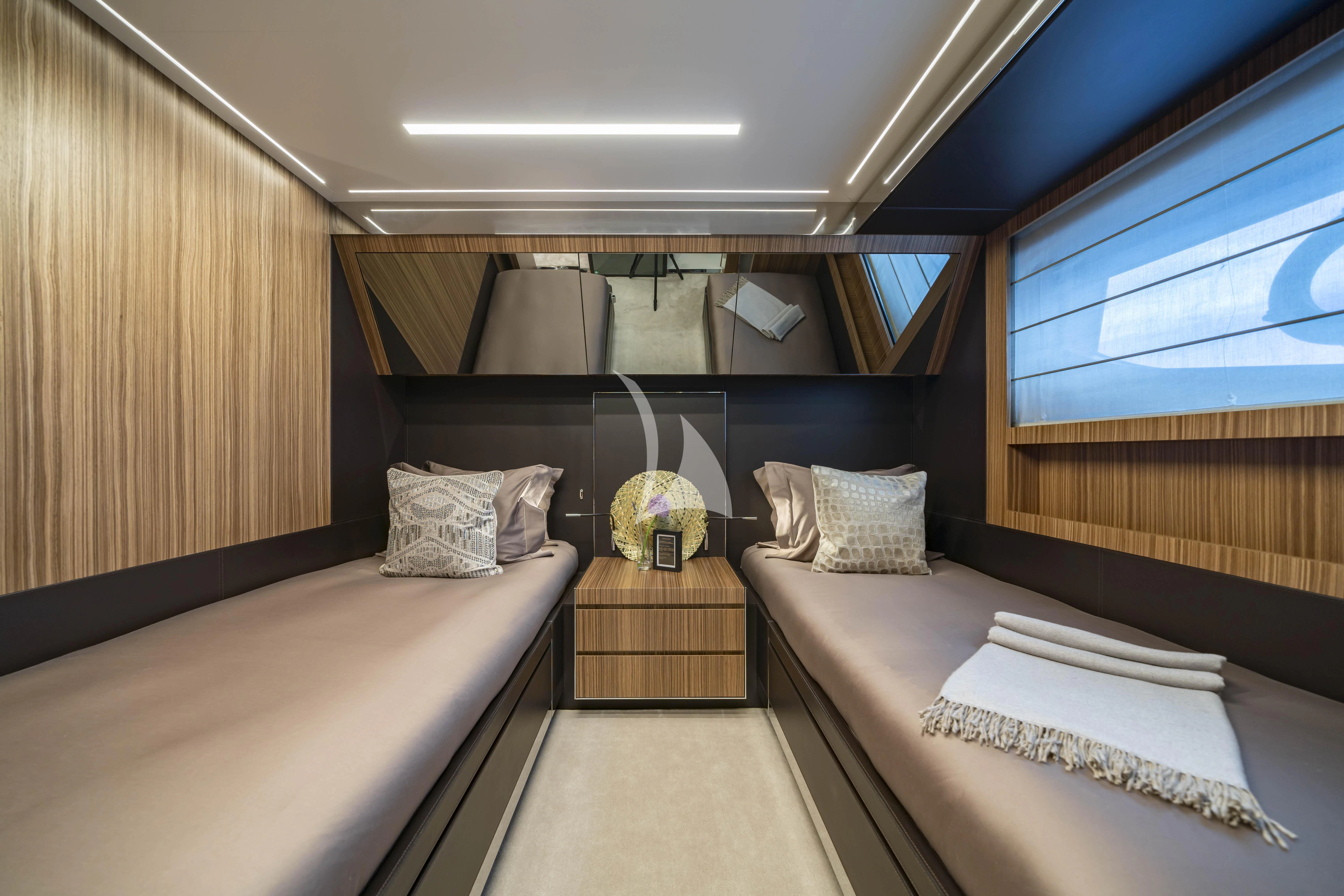 a room with beds and a window aboard HP6 Yacht for Charter
