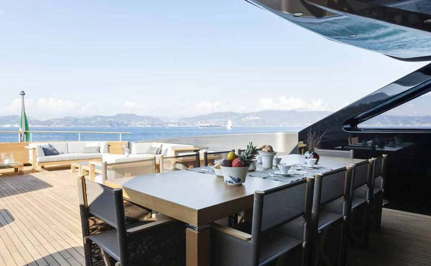a table with chairs and a view of the ocean aboard SIMPLY EIGHT Yacht for Sale
