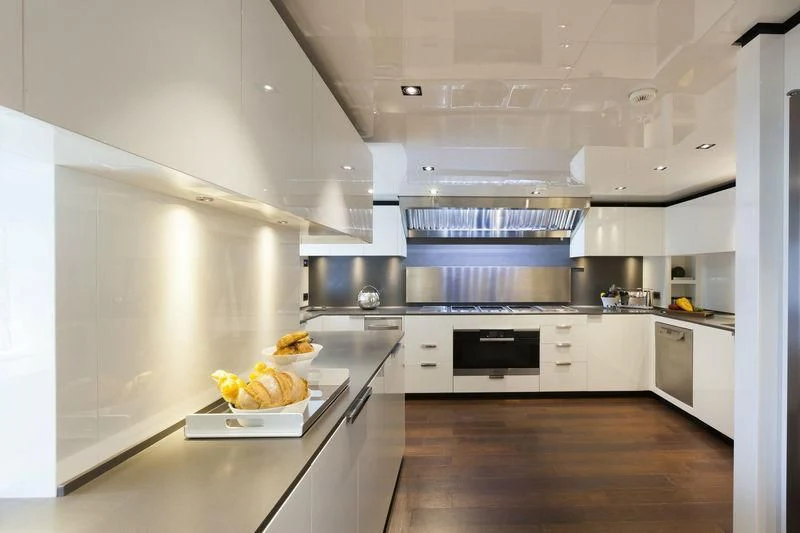 a kitchen with white cabinets aboard SIMPLY EIGHT Yacht for Sale
