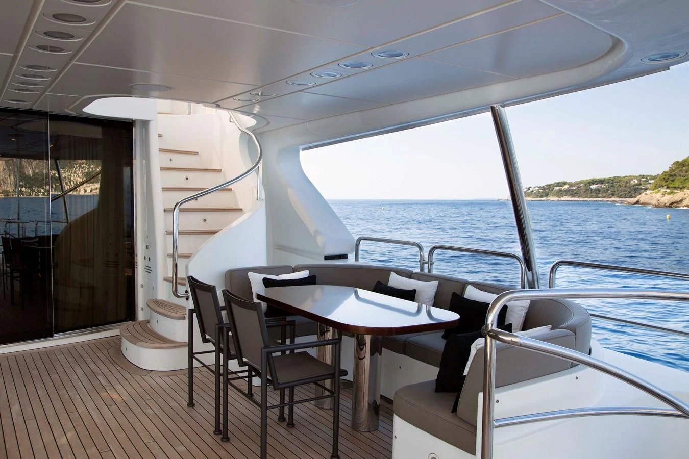 a deck with a table and chairs on it aboard MINA Yacht for Sale