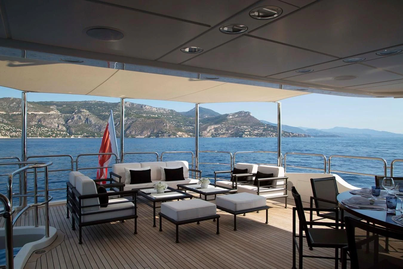 a patio with a table and chairs aboard MINA Yacht for Sale