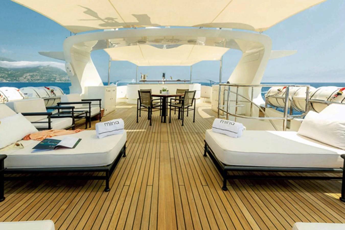 a room with a bed and a table and chairs aboard MINA Yacht for Sale