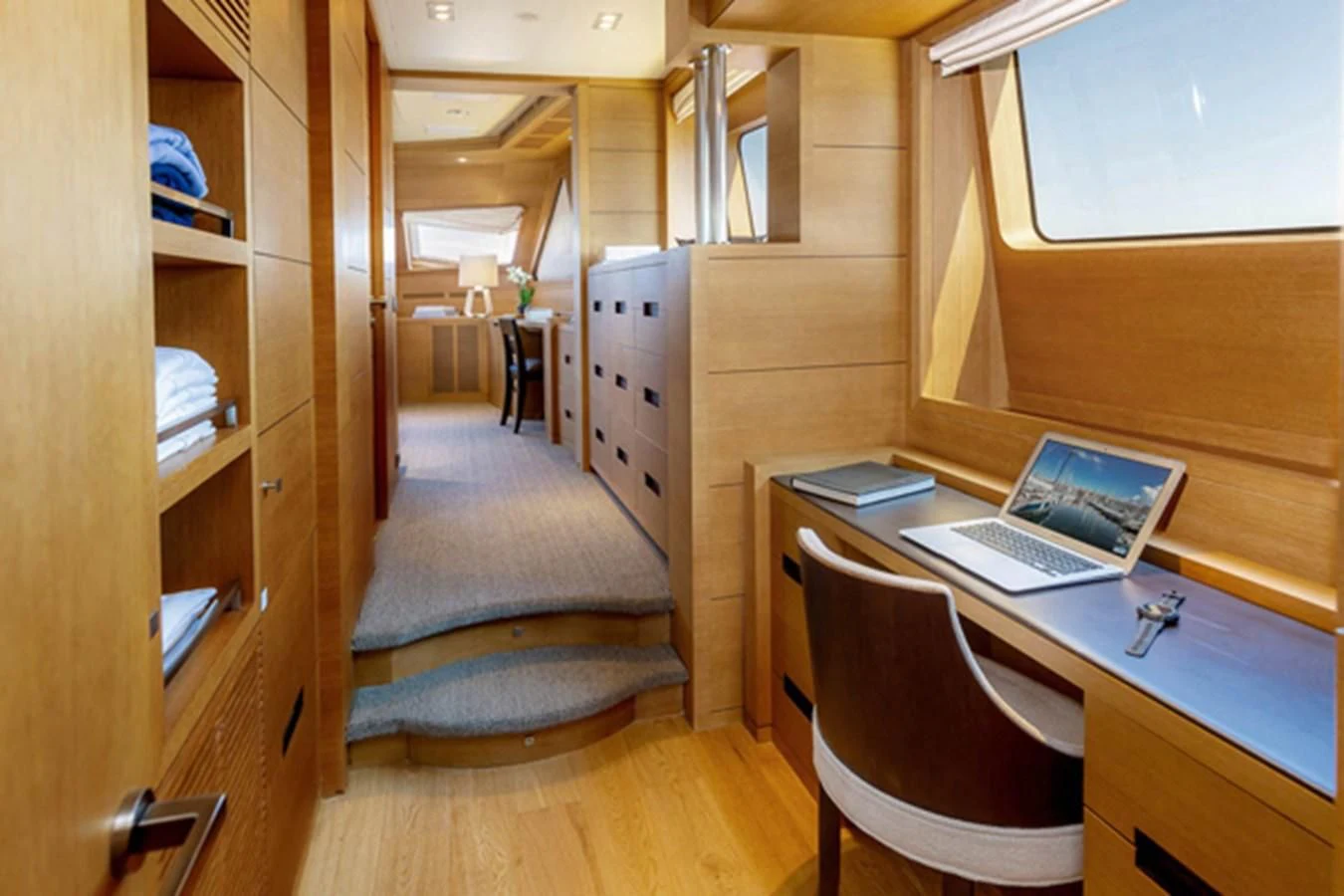 a laptop on a desk aboard MINA Yacht for Sale