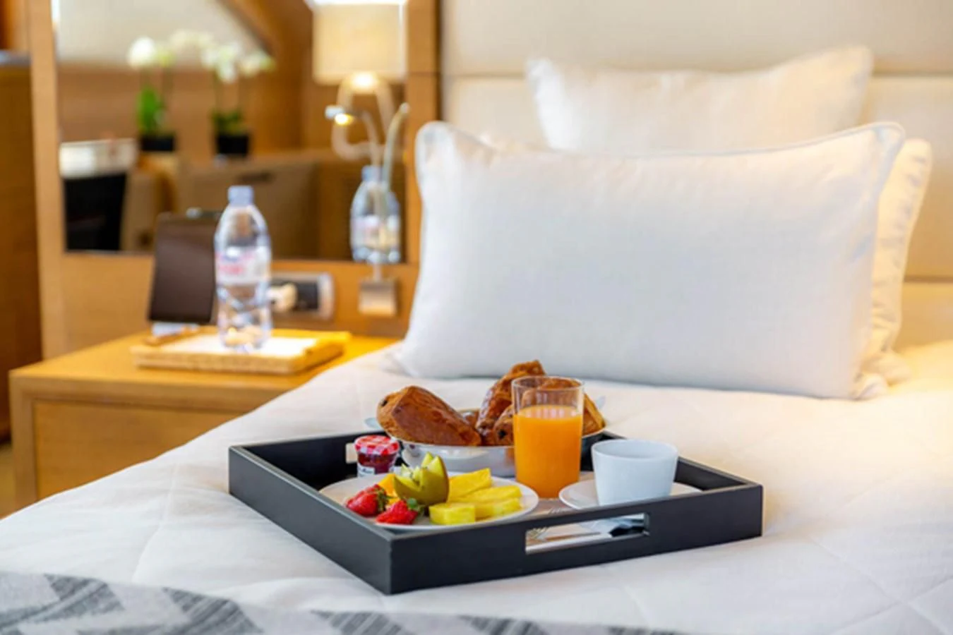 a tray of food on a bed aboard MINA Yacht for Sale