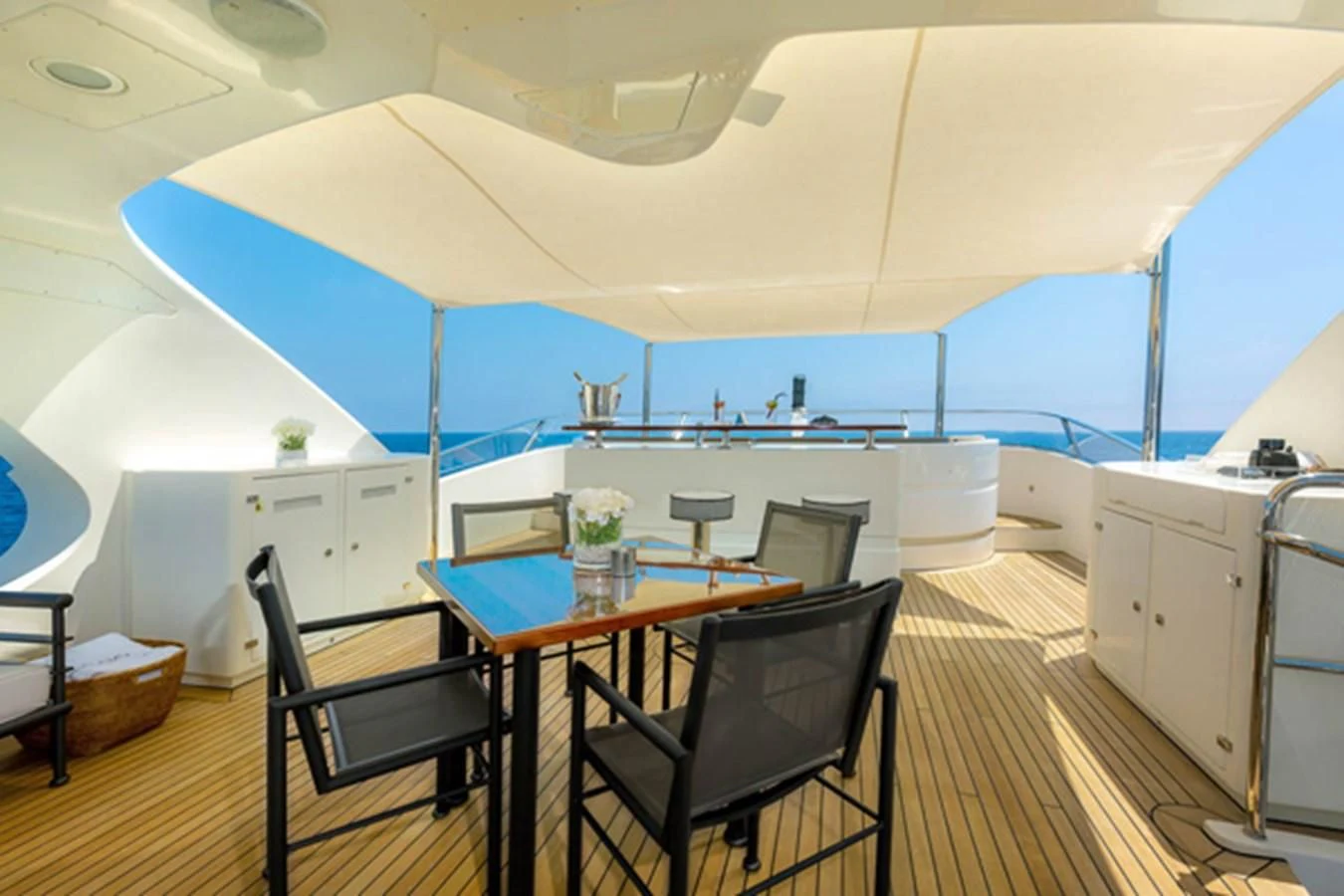 a dining table and chairs on a boat aboard MINA Yacht for Sale