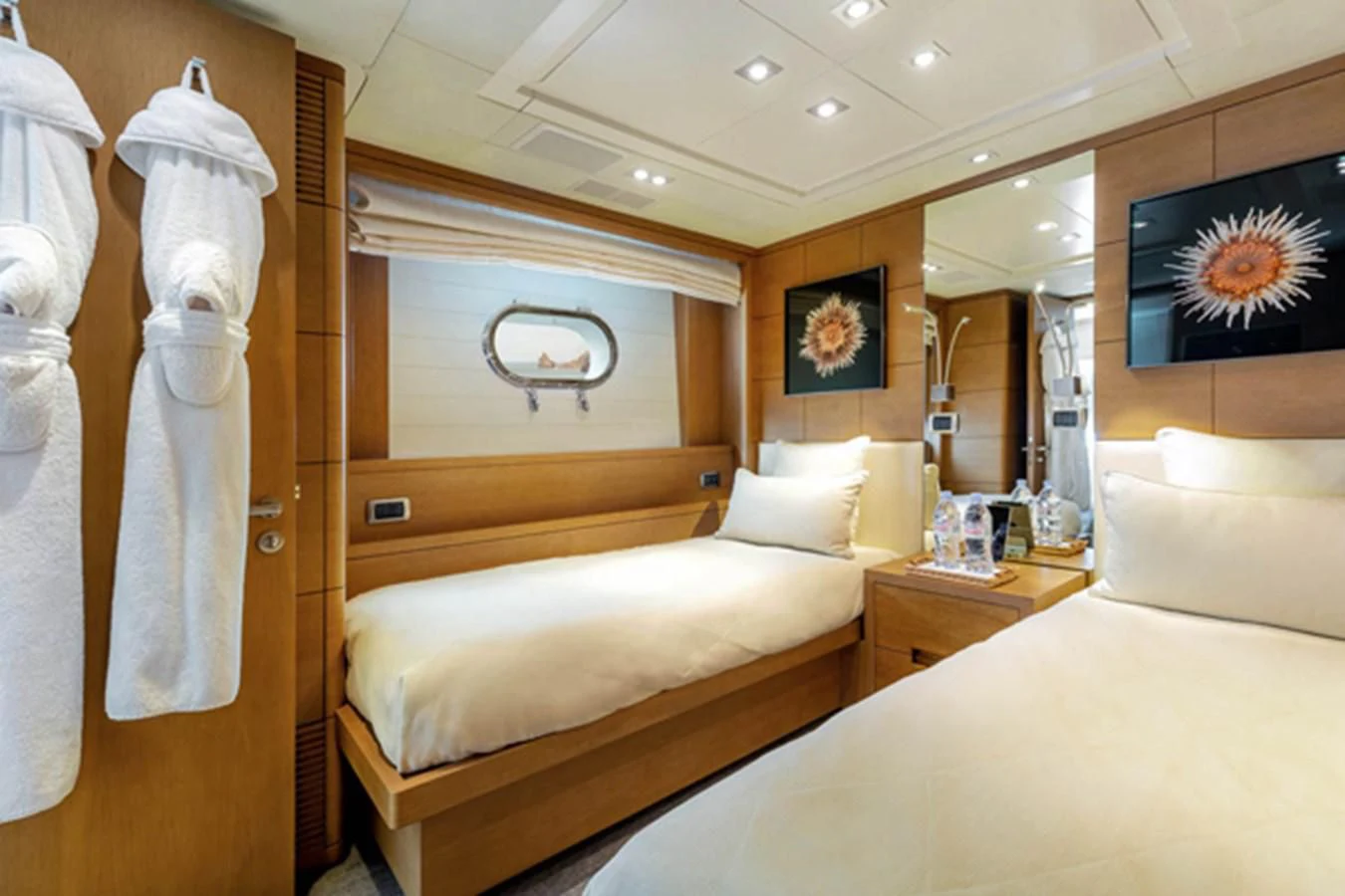 a room with a bed and a mirror aboard MINA Yacht for Sale