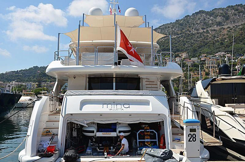 a boat with a flag on the front aboard MINA Yacht for Sale