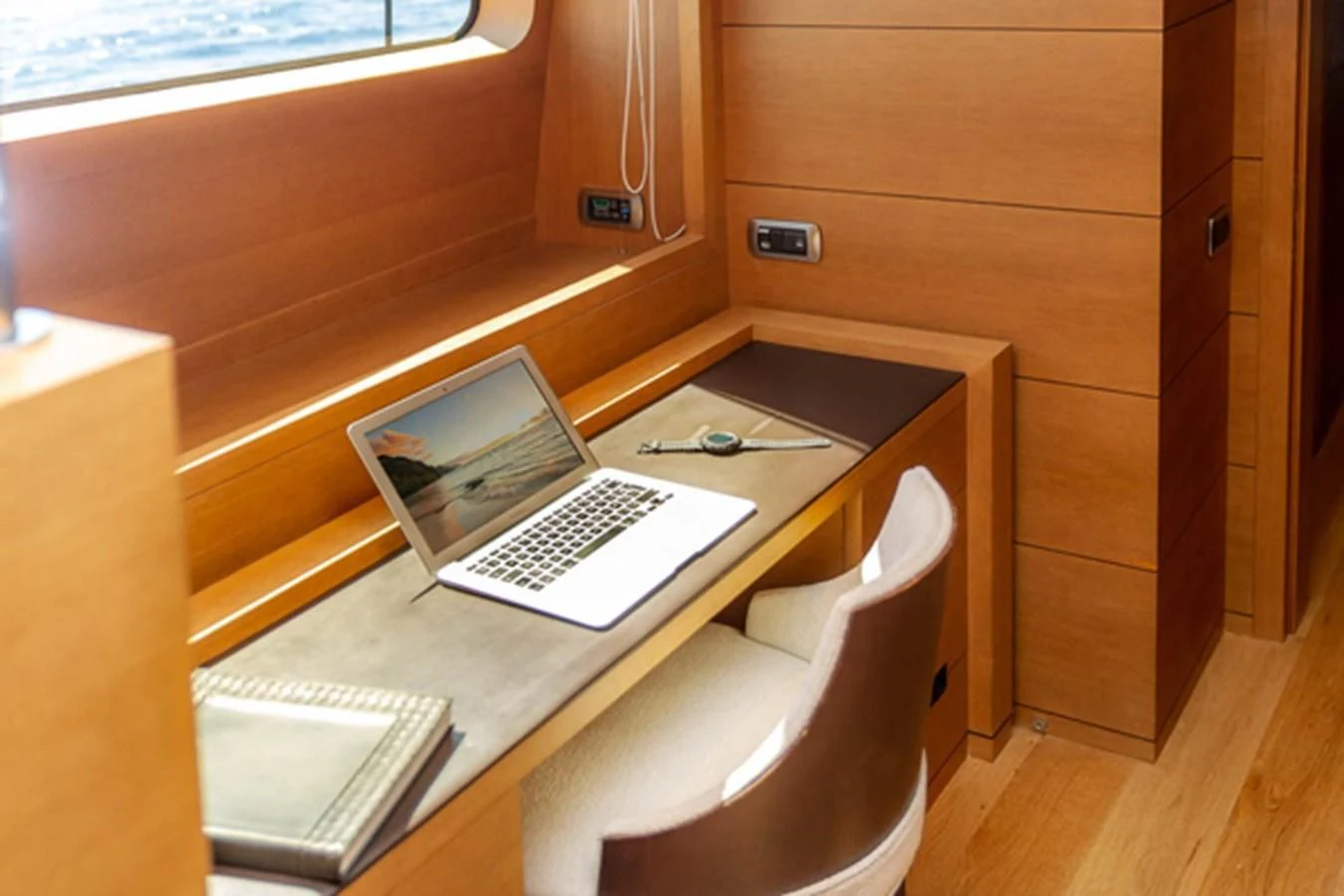 a laptop on a table aboard MINA Yacht for Sale