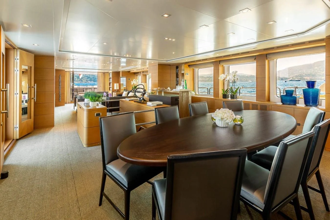 a large dining table in a large room aboard MINA Yacht for Sale