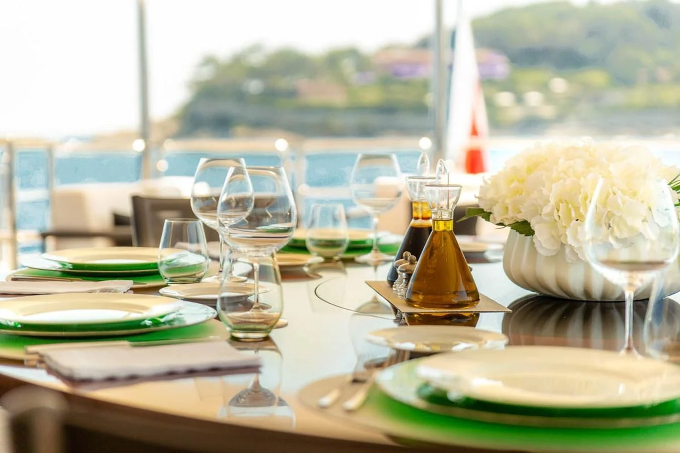 a table with plates and glasses aboard MINA Yacht for Sale