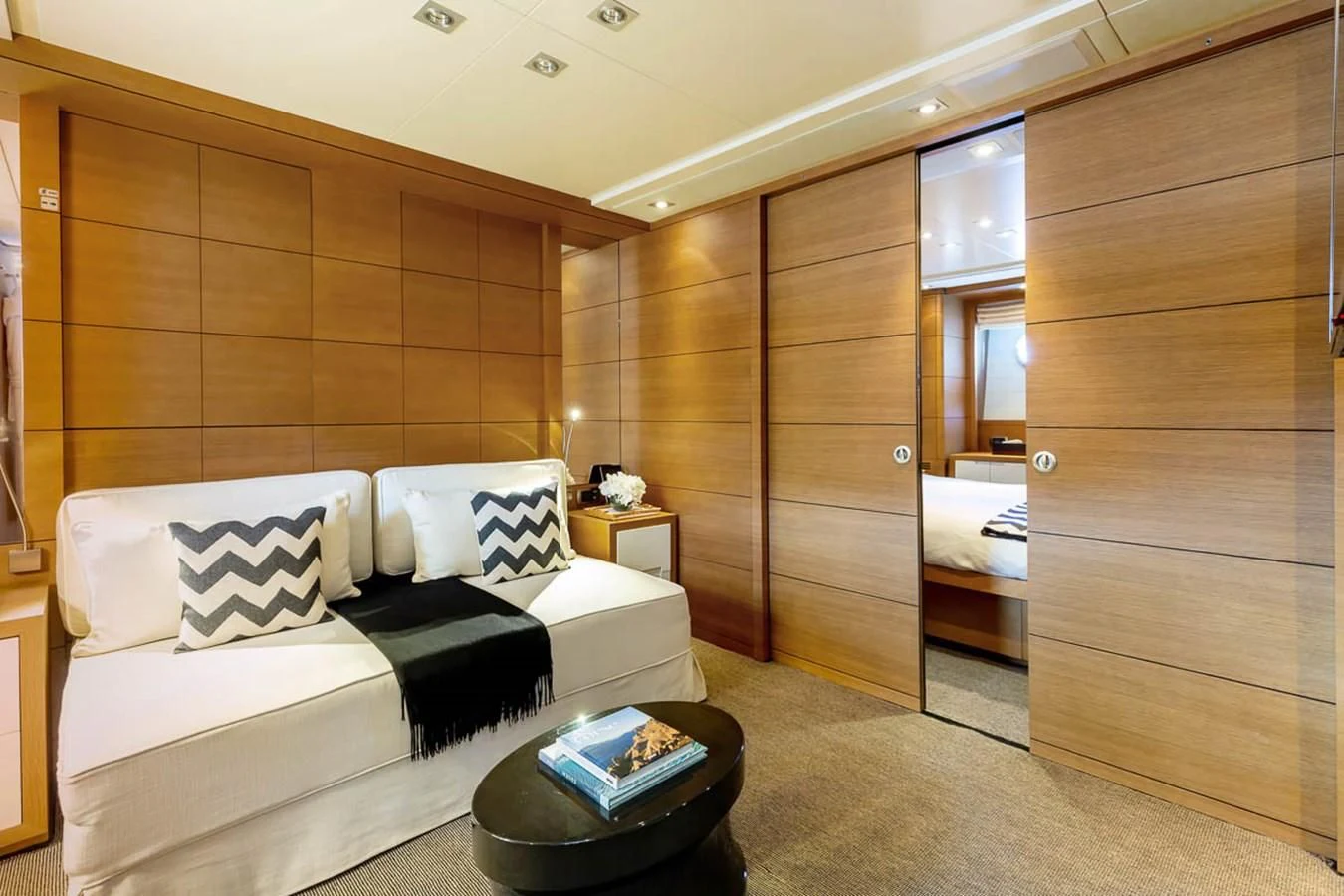 a room with a bed and a wood cabinet aboard MINA Yacht for Sale