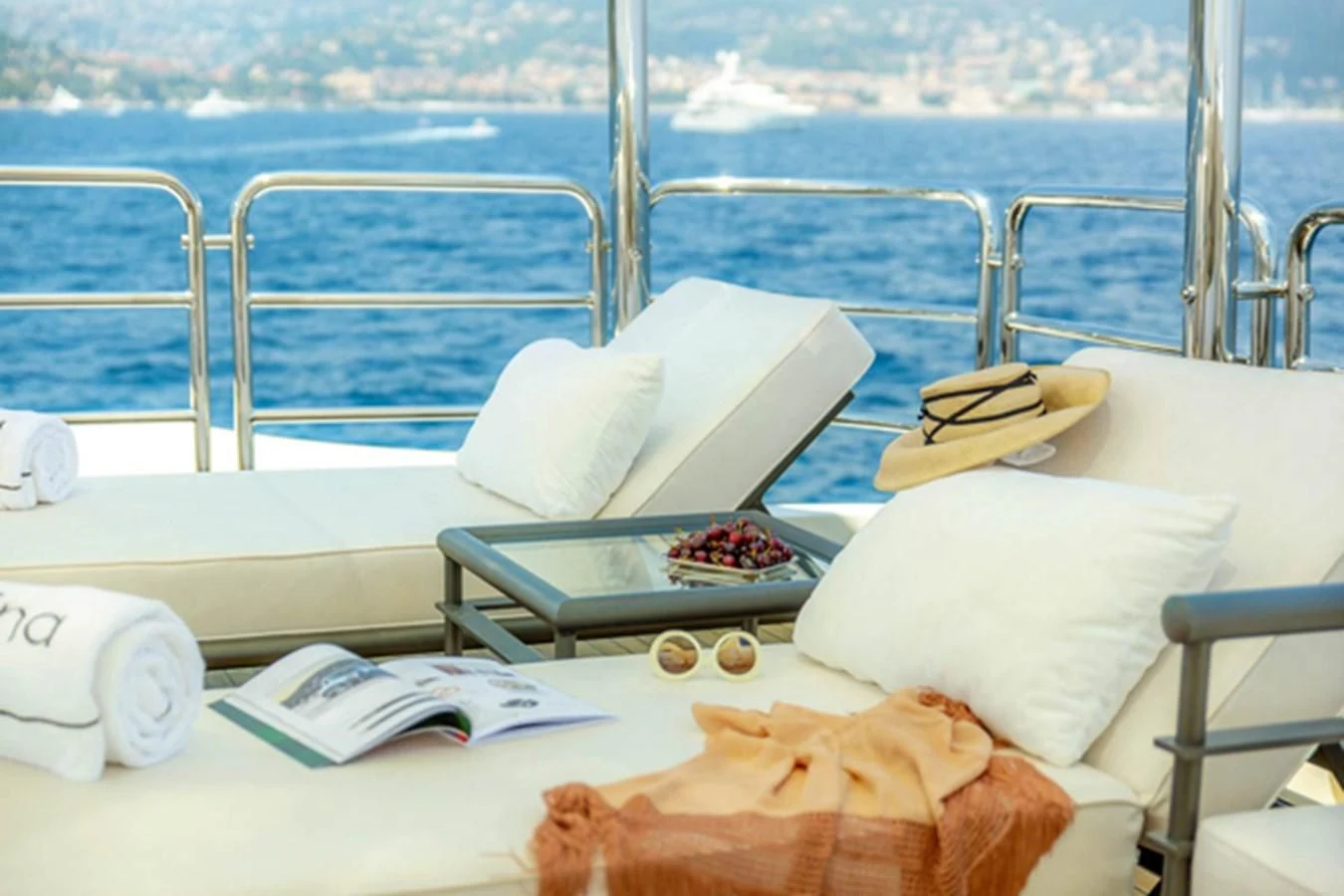 a white couch with a coffee table and a pillow on a boat aboard MINA Yacht for Sale
