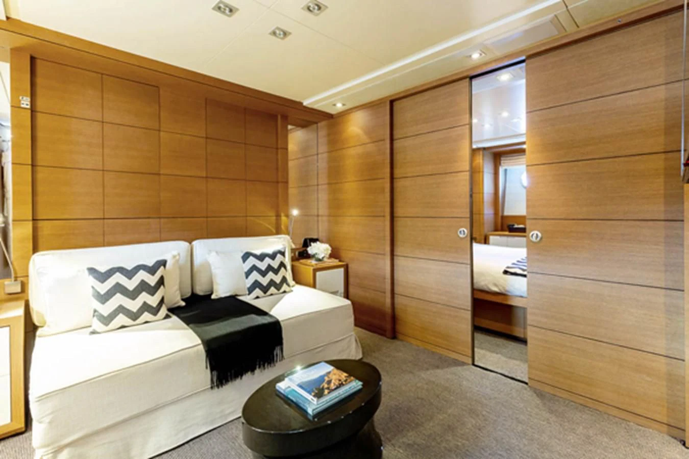 a room with a bed and a wood cabinet aboard MINA Yacht for Sale