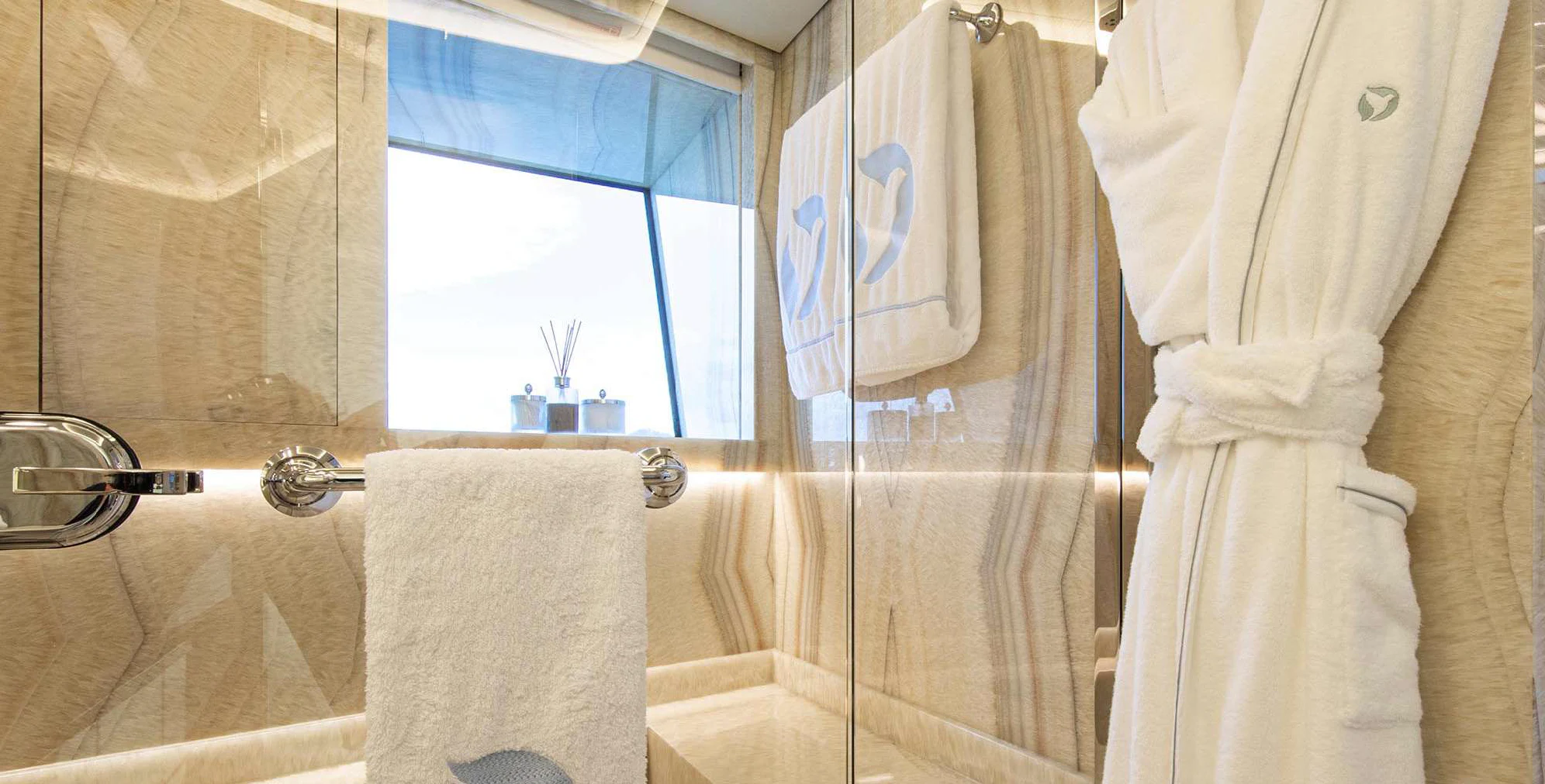 a bathroom with a shower curtain and towels aboard OCEANBIRD Yacht for Sale