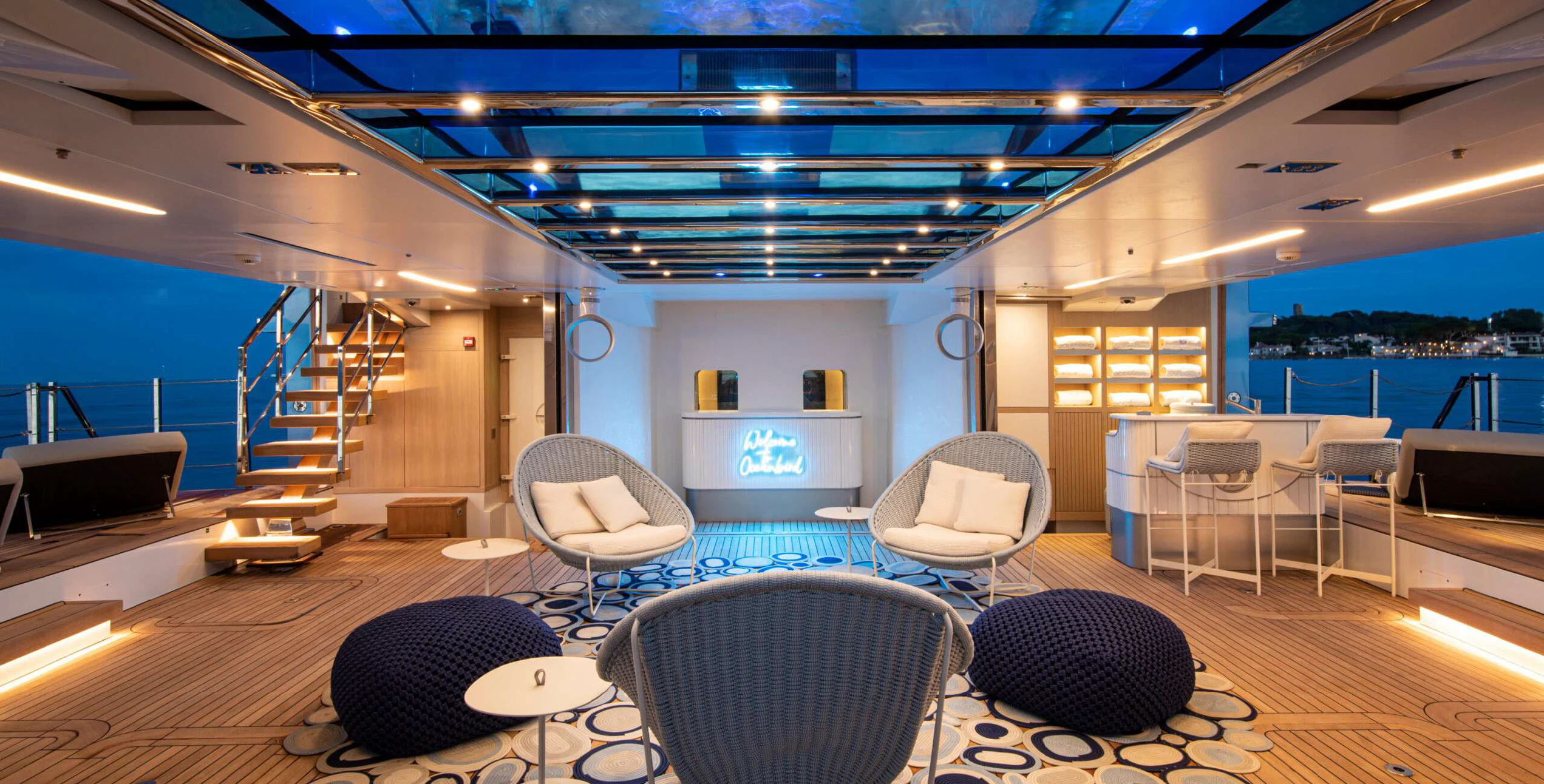 a large room with chairs and a table and a view of the water aboard OCEANBIRD Yacht for Sale