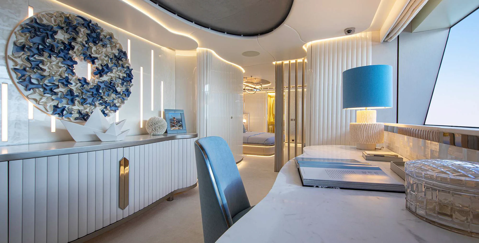 a room with a large bed and a blue chair aboard OCEANBIRD Yacht for Sale