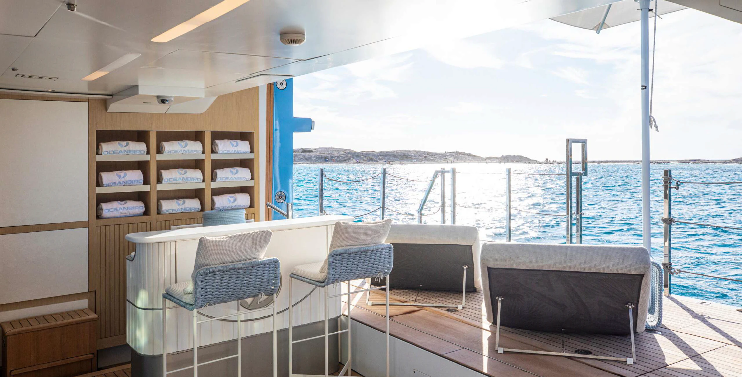 a room with a bed and a table and chairs aboard OCEANBIRD Yacht for Sale