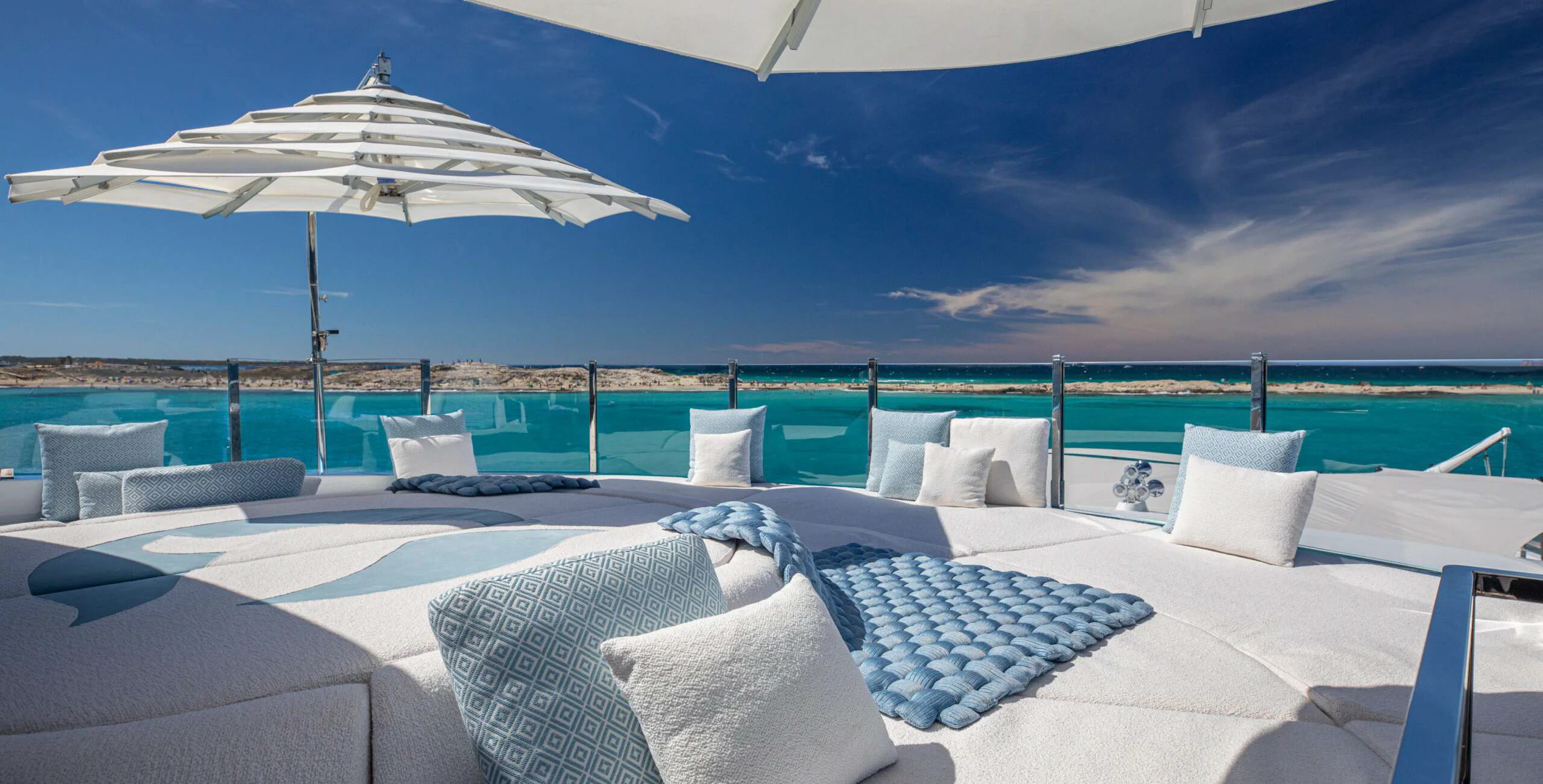 a large patio with a large white umbrella over it aboard OCEANBIRD Yacht for Sale