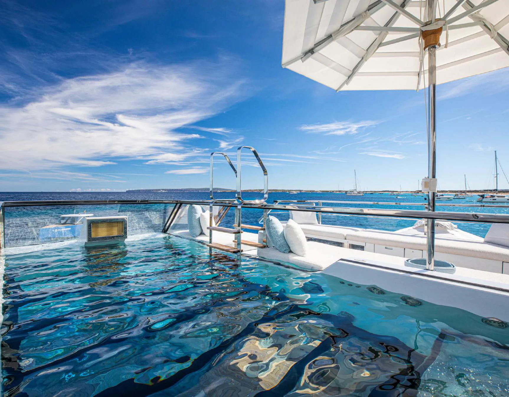 a swimming pool with a white umbrella aboard OCEANBIRD Yacht for Sale