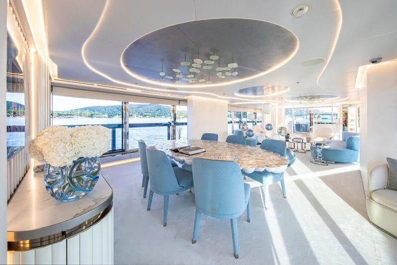 a large dining room with a large chandelier aboard OCEANBIRD Yacht for Sale