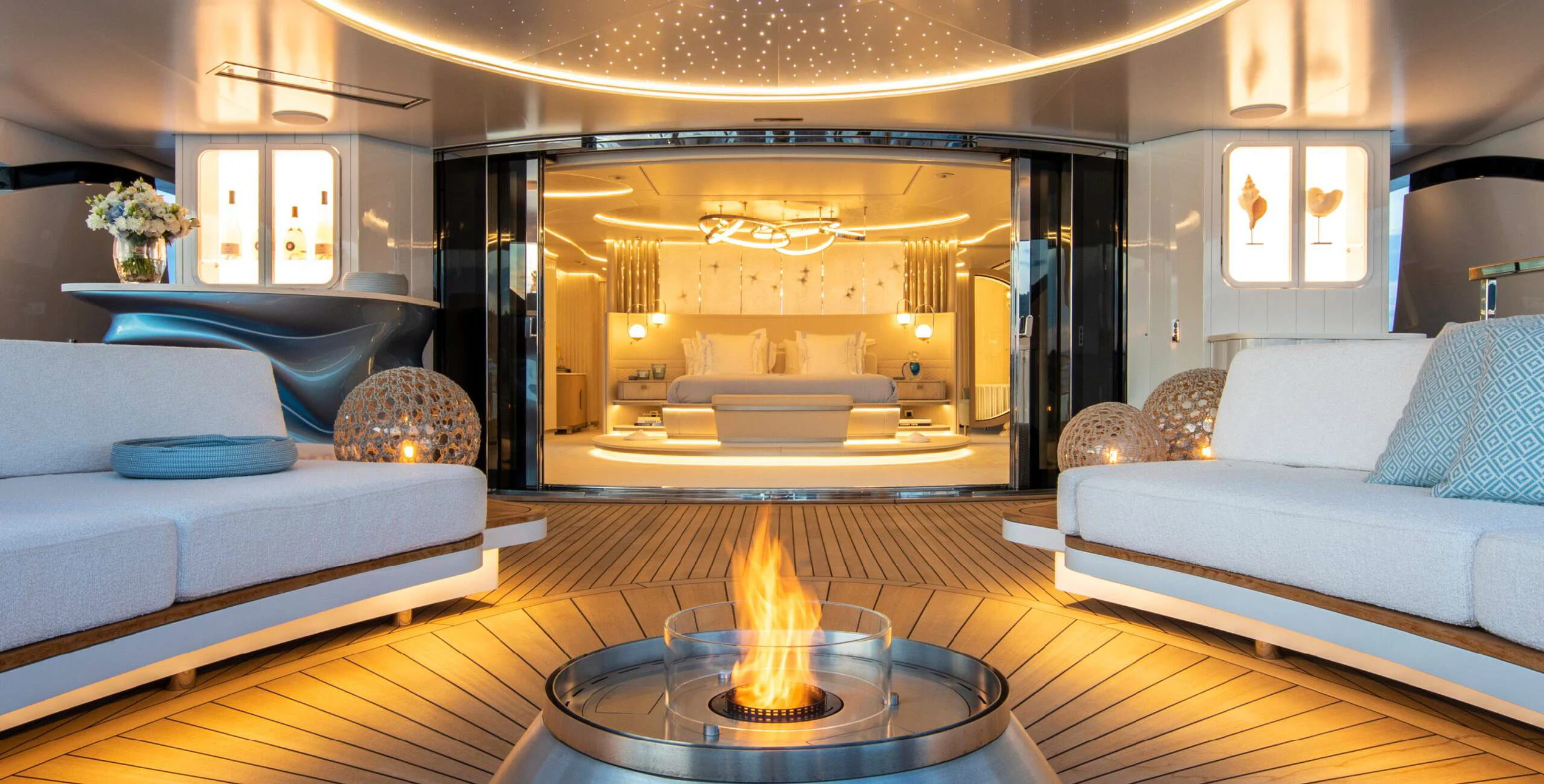 a living room with a fireplace aboard OCEANBIRD Yacht for Sale