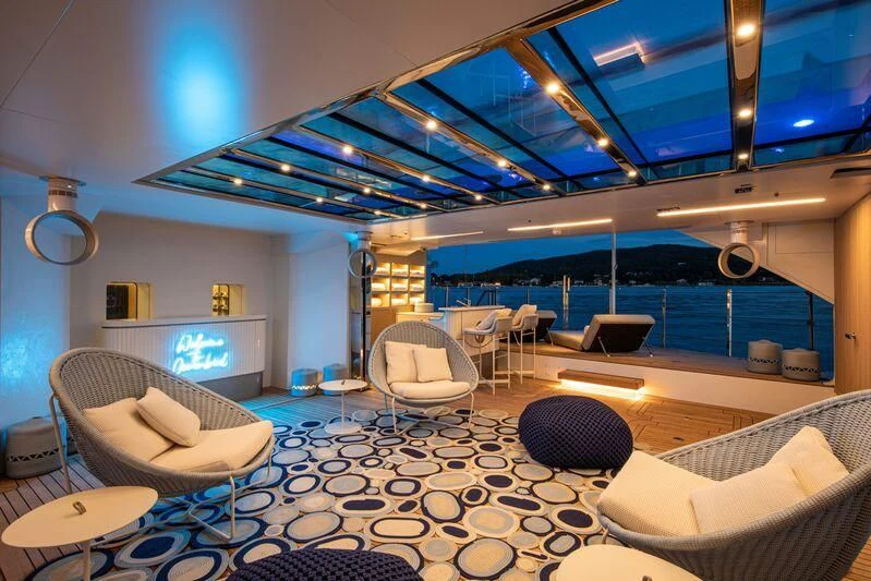 a large room with a large swimming pool and a large screen aboard OCEANBIRD Yacht for Sale