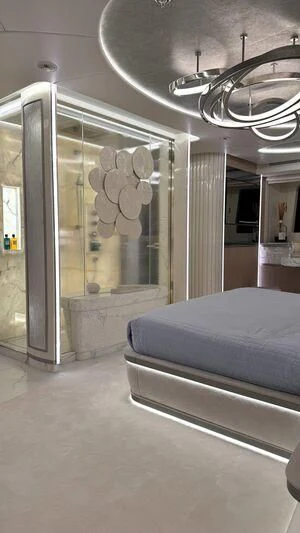 a room with a bed and a mirror aboard OCEANBIRD Yacht for Sale