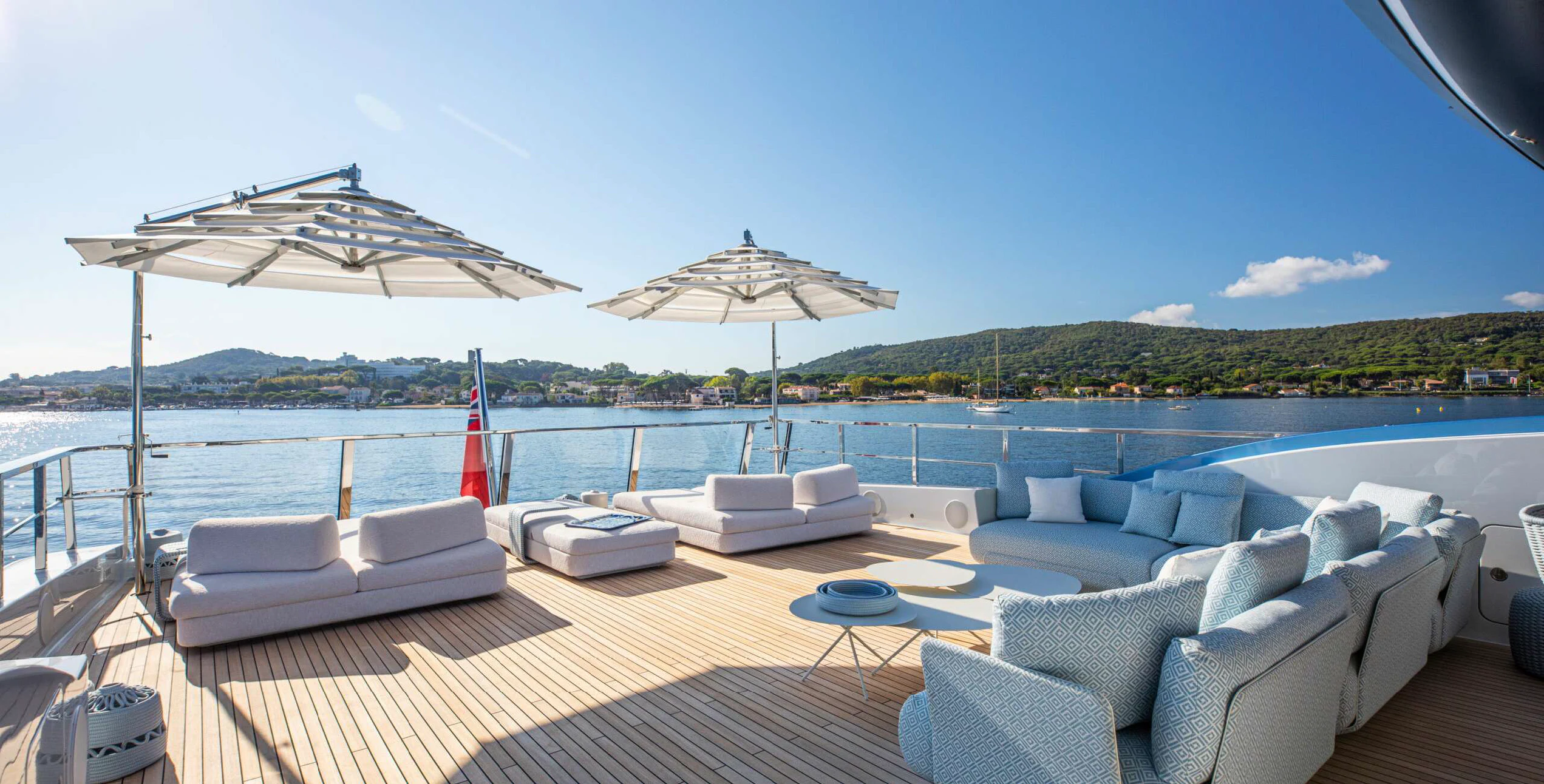 a large lounge area with lounge chairs and umbrellas on it aboard OCEANBIRD Yacht for Sale