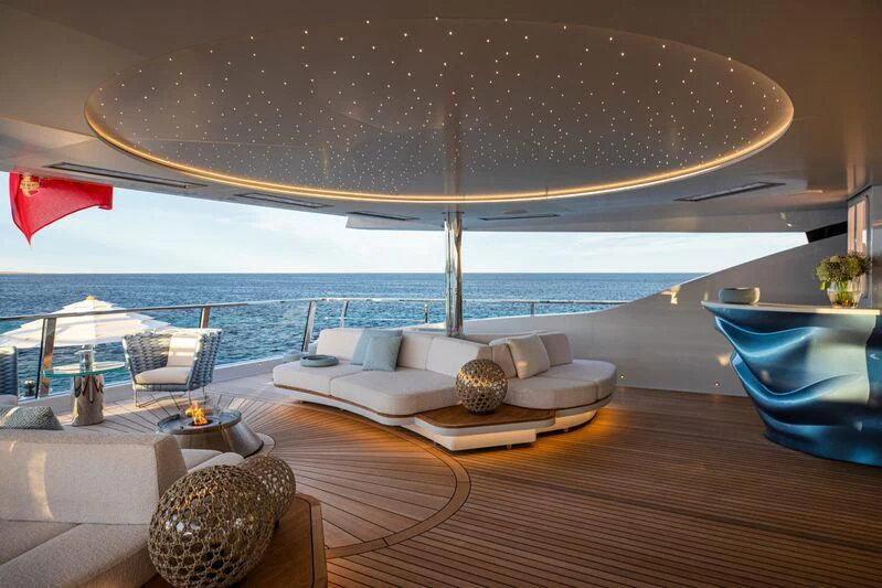 a large lounge area with a large umbrella over it aboard OCEANBIRD Yacht for Sale