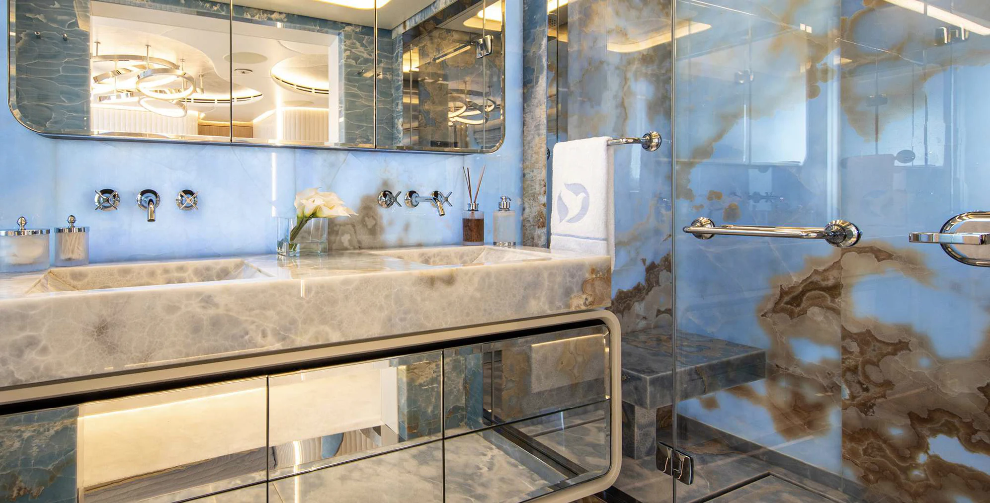 a bathroom with a sink and a large mirror aboard OCEANBIRD Yacht for Sale