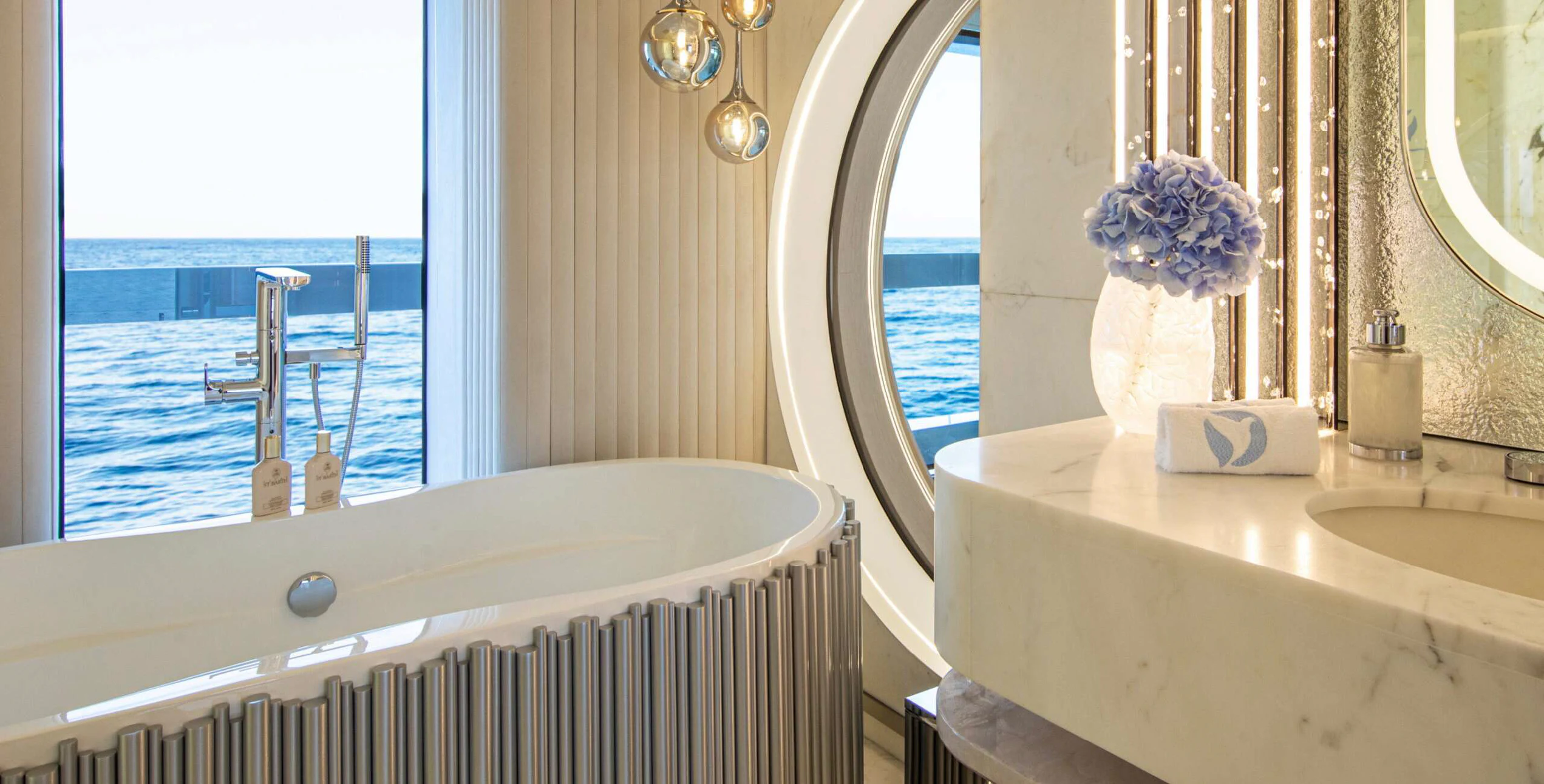 a bathroom with a tub sink and a window aboard OCEANBIRD Yacht for Sale