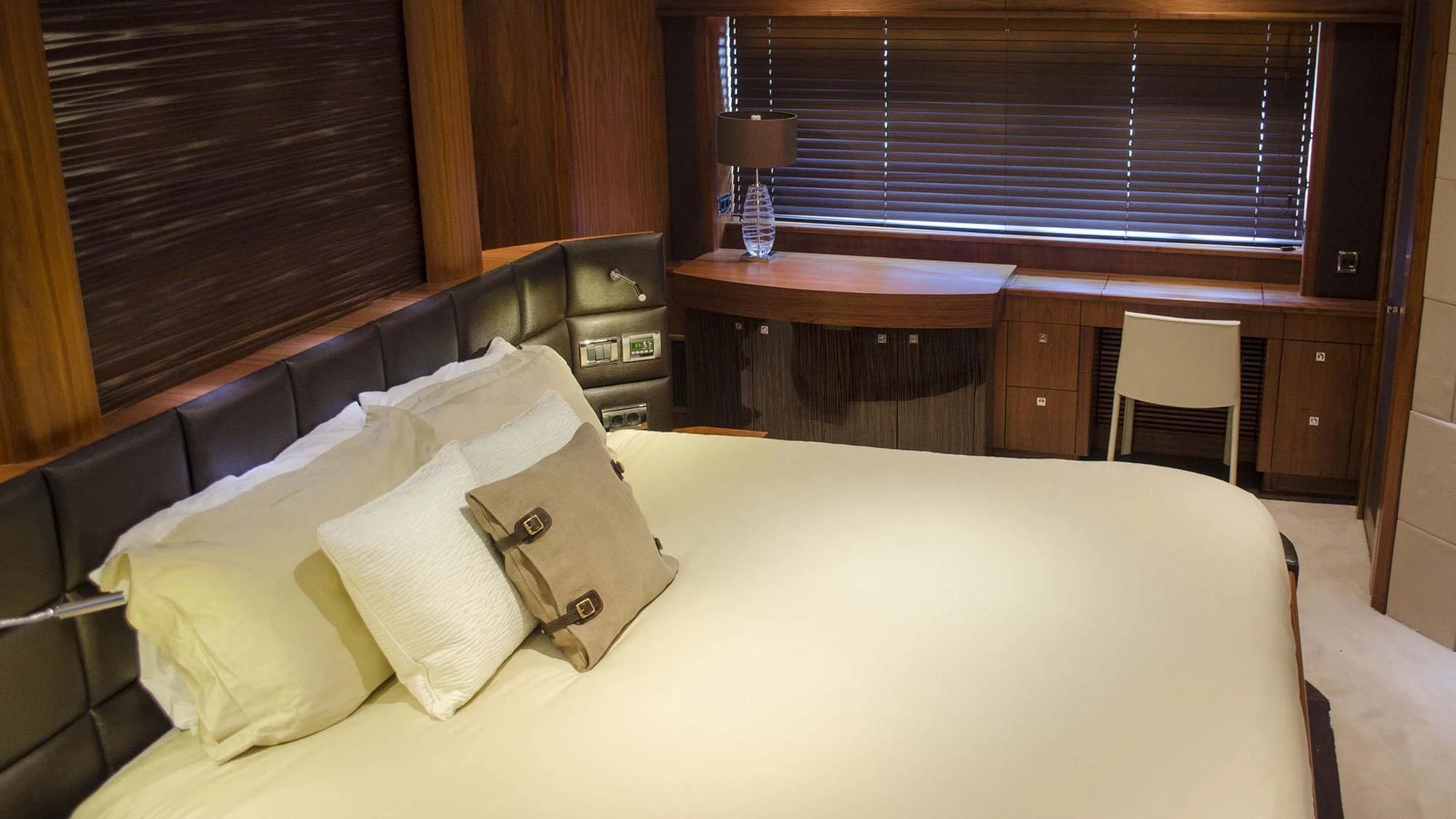 a bed with white sheets and pillows aboard EMRYS Yacht for Sale
