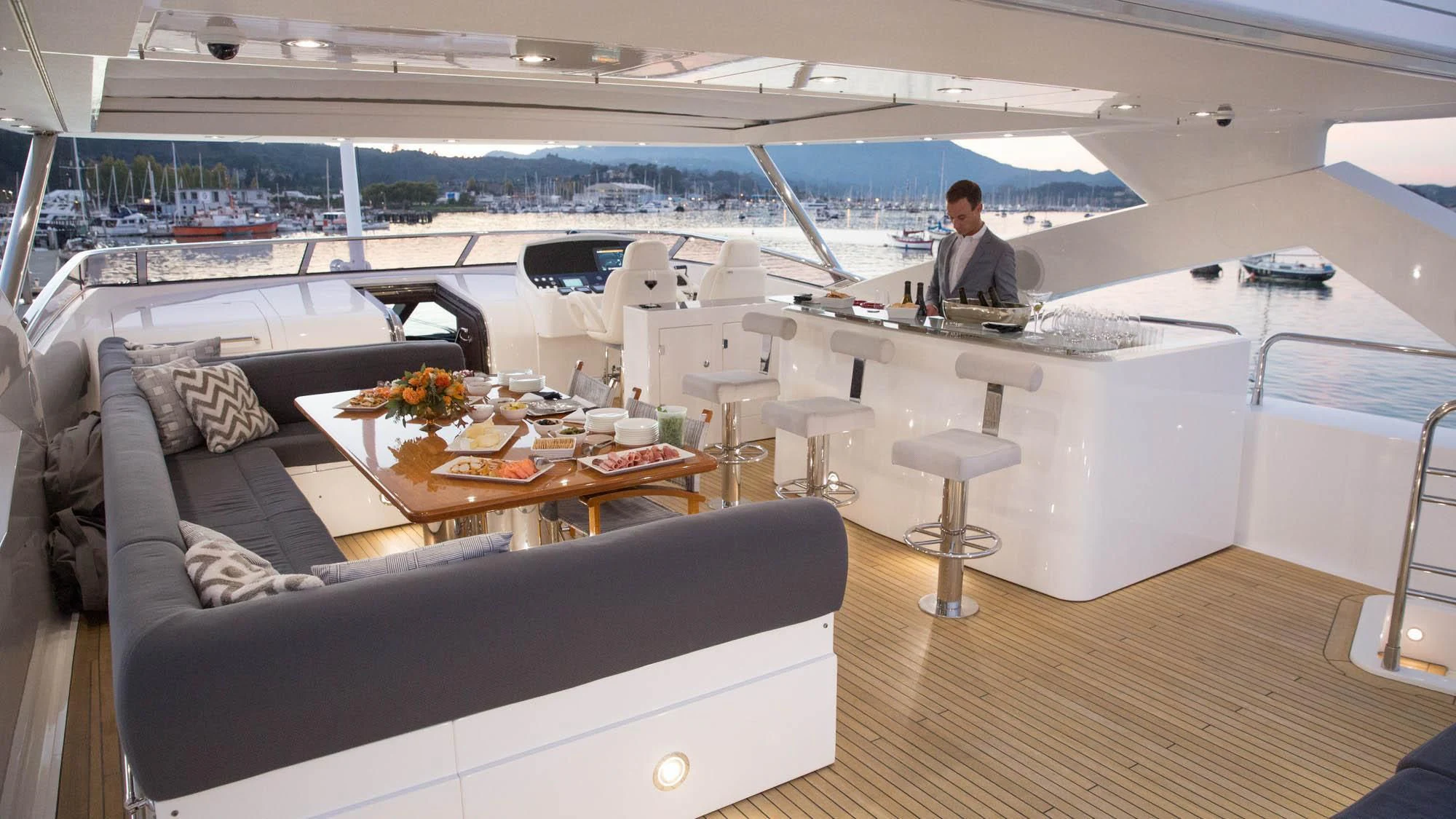 a person sitting at a table in a room with a large window aboard EMRYS Yacht for Sale