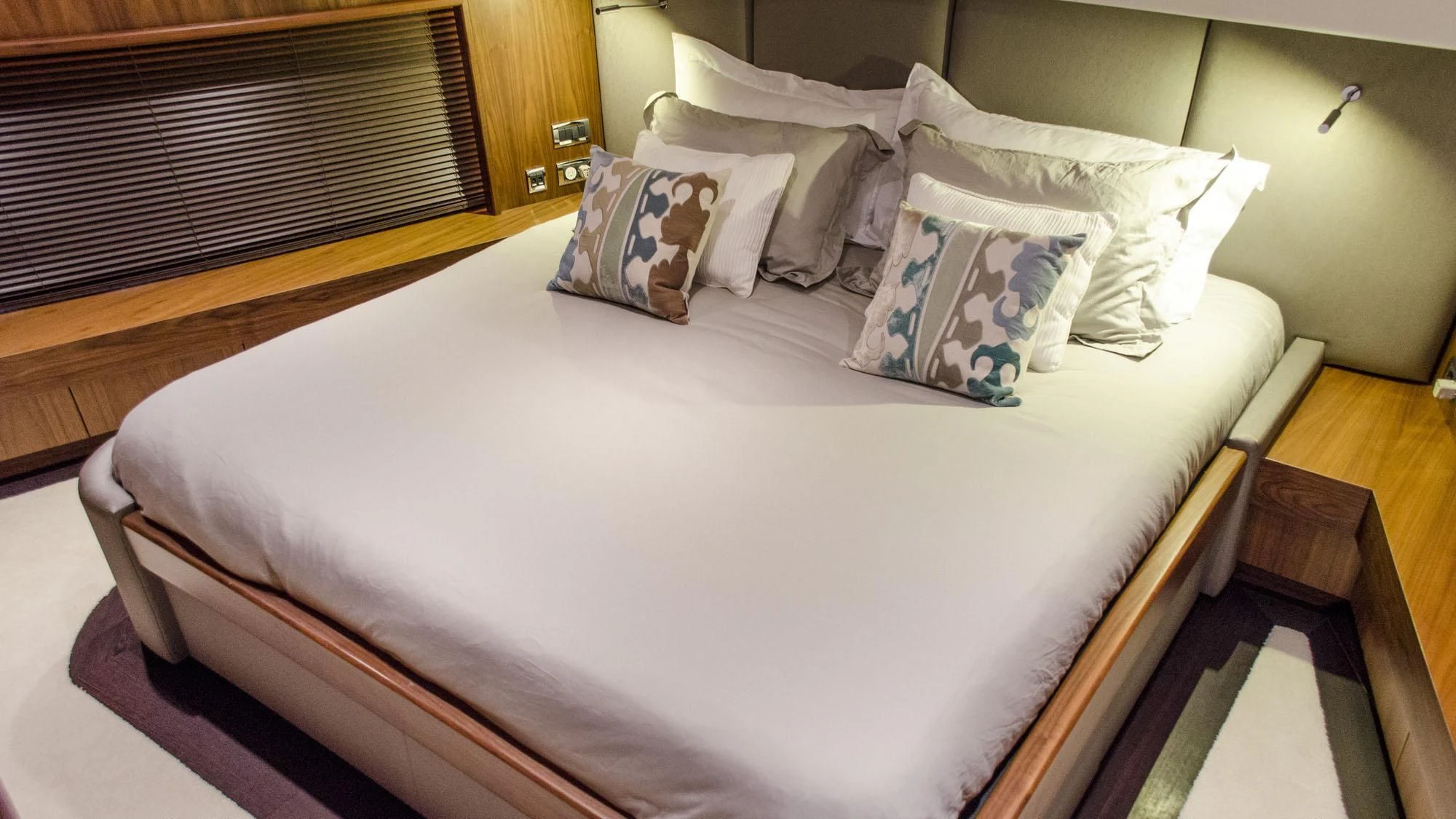 a bed with white sheets aboard EMRYS Yacht for Sale