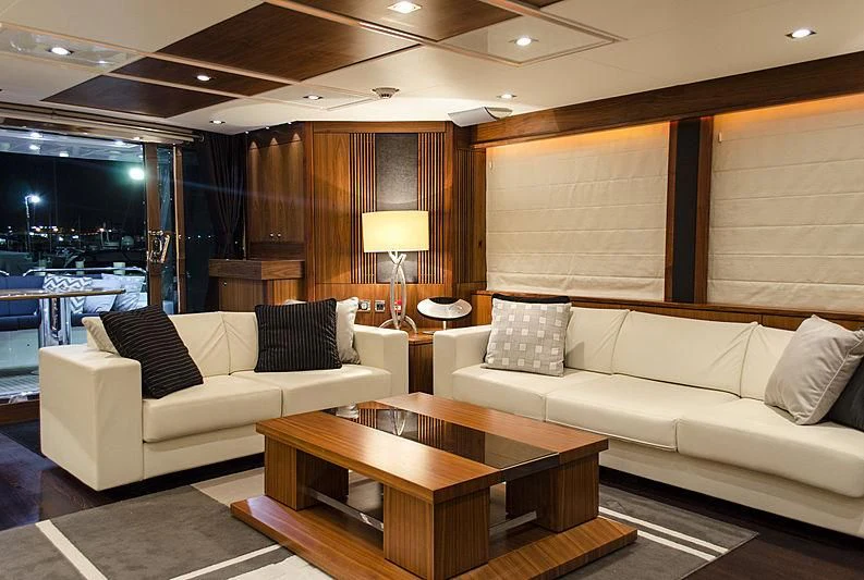 a living room with a couch and a table aboard EMRYS Yacht for Sale