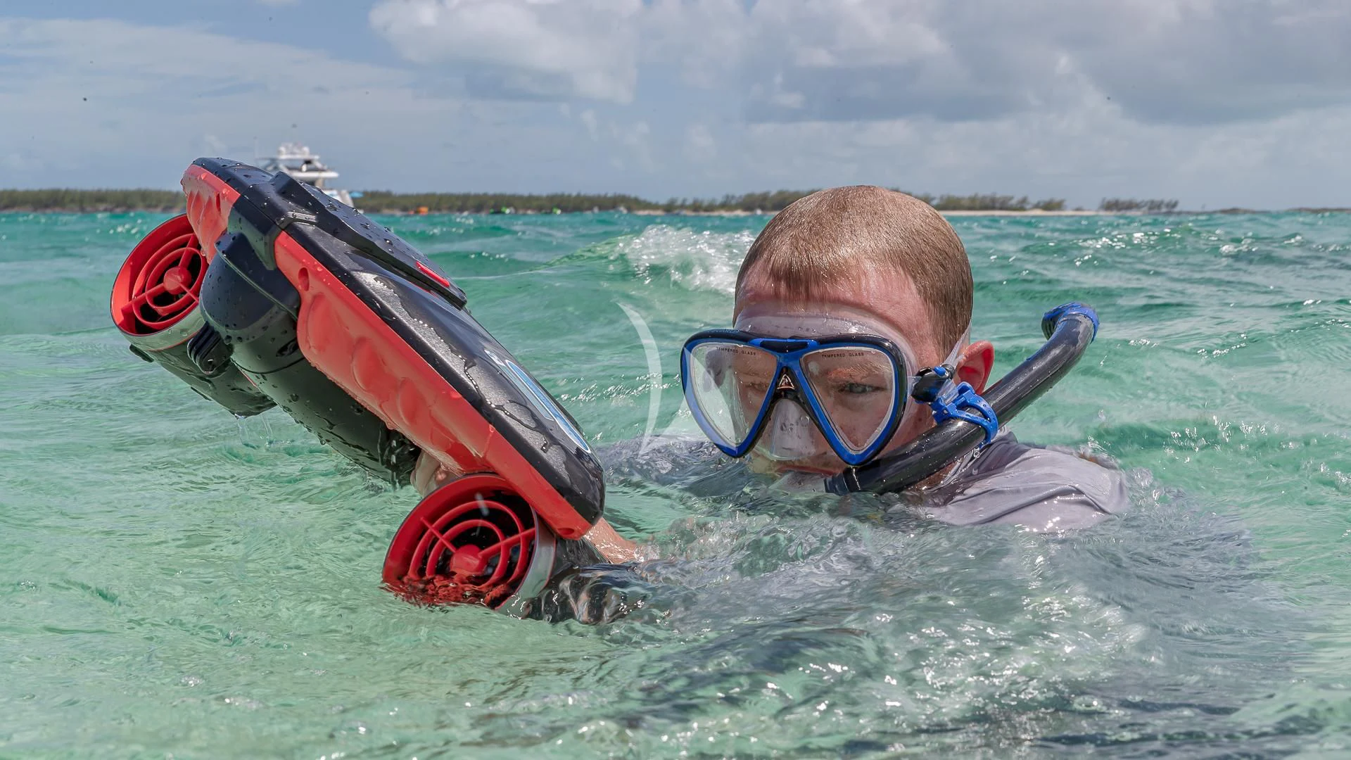 a boy in a life jacket on a jet ski in the water aboard EMRYS Yacht for Sale