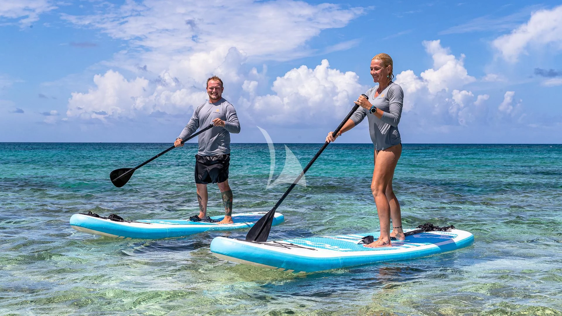 a couple of men on paddle boards aboard EMRYS Yacht for Sale