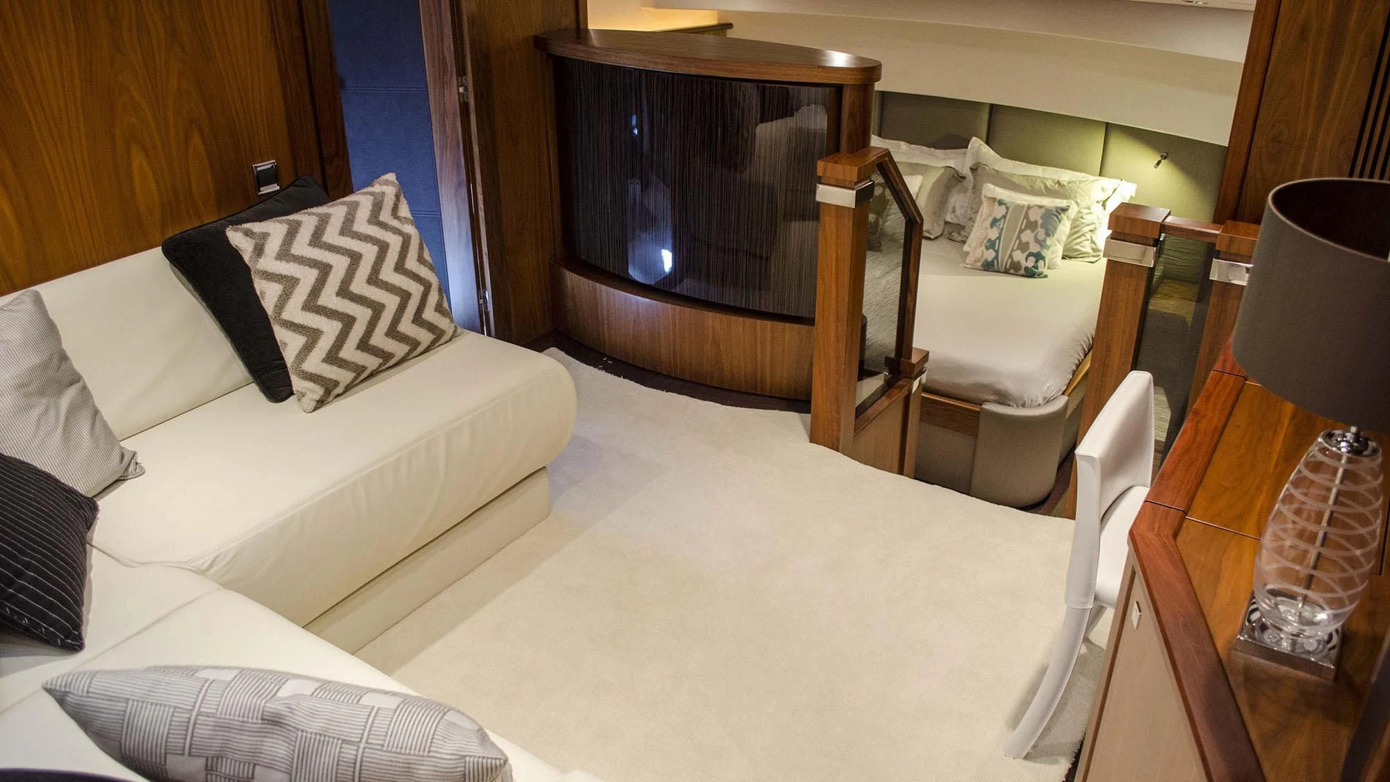 a bedroom with a bed and a chair aboard EMRYS Yacht for Sale