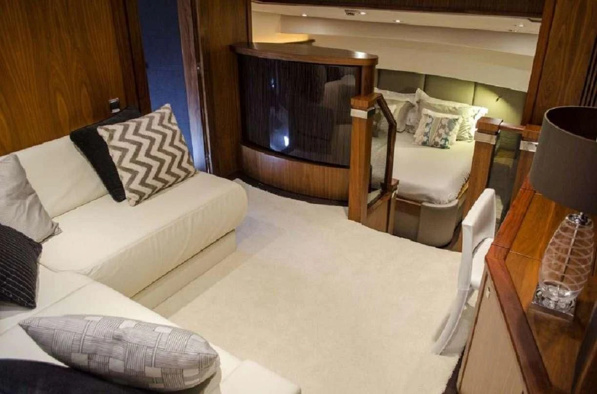 a living room with a white couch and a television aboard EMRYS Yacht for Sale