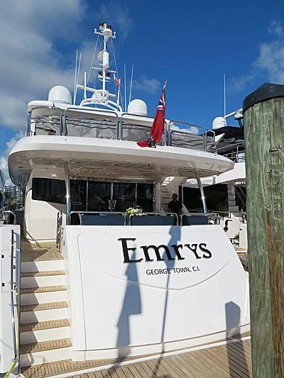 a boat with a staircase and a flag on the front aboard EMRYS Yacht for Sale