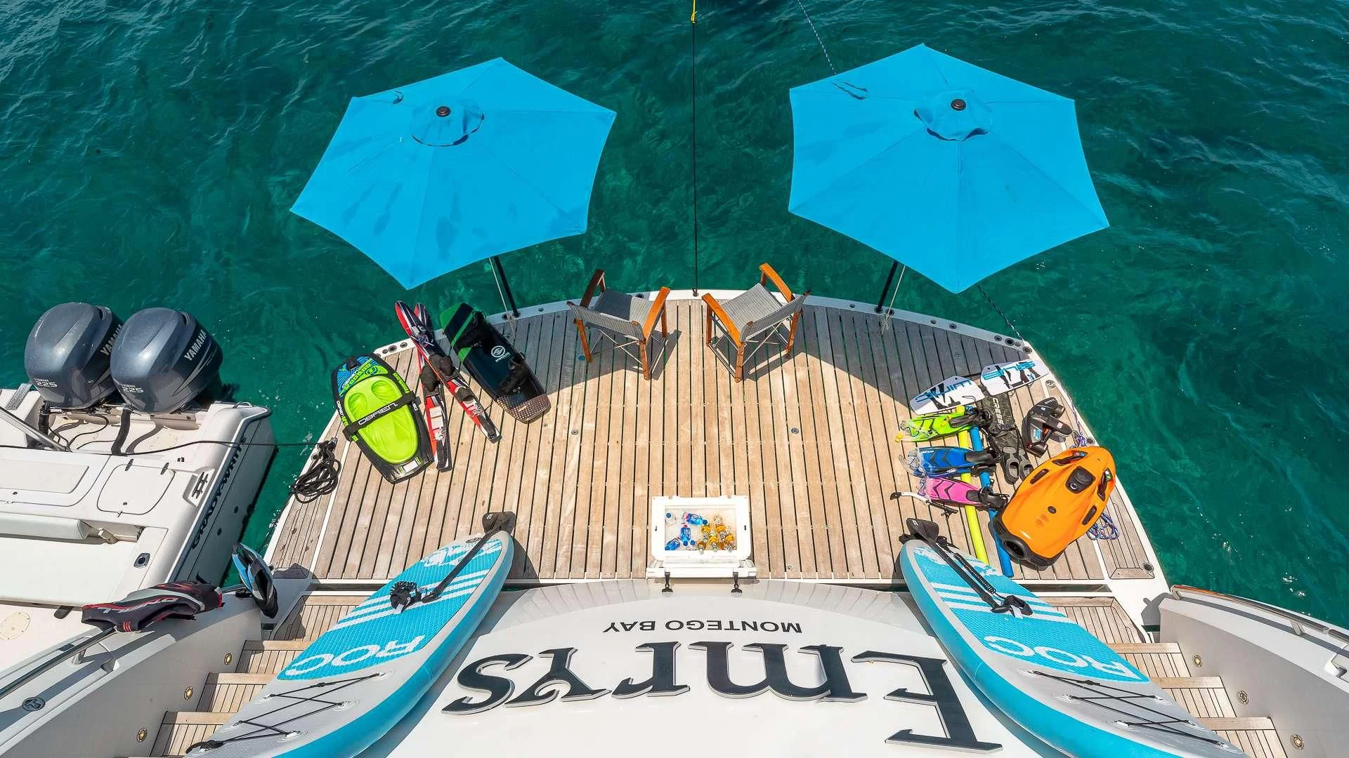 a boat with a blue umbrella on it aboard EMRYS Yacht for Sale