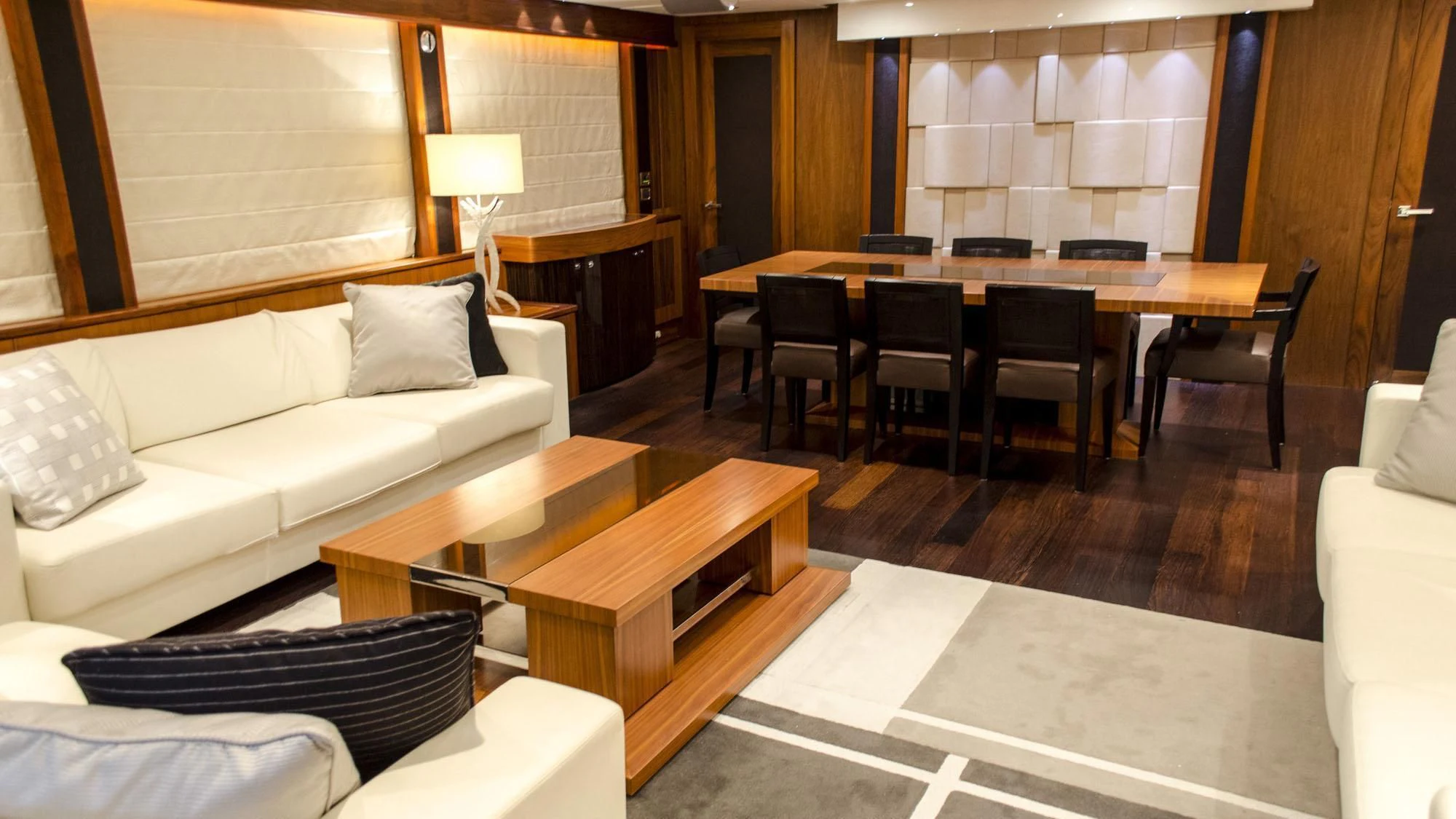 a living room with a couch and a table aboard EMRYS Yacht for Sale