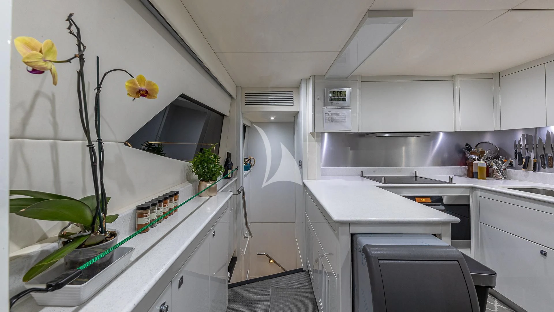 a kitchen with white cabinets aboard EMRYS Yacht for Sale