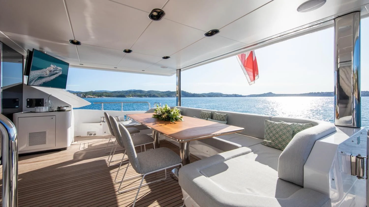 a large open living room with a large balcony overlooking the ocean aboard CLOUDY BAY Yacht for Sale