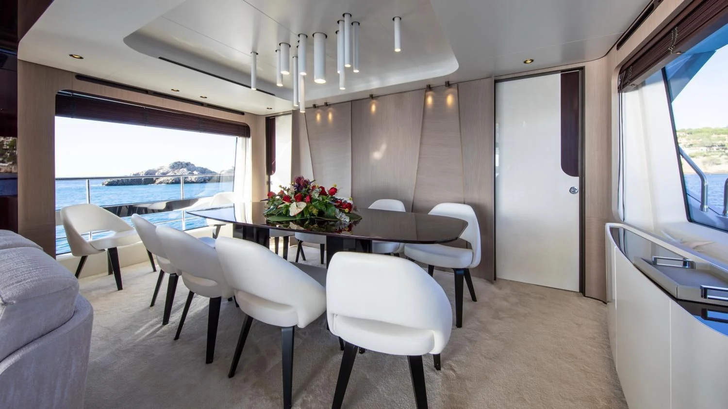 a room with a table and chairs aboard CLOUDY BAY Yacht for Sale